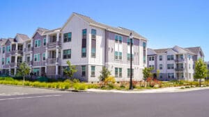 apartment-building-exterior-with-a-parking-area-and-lawn