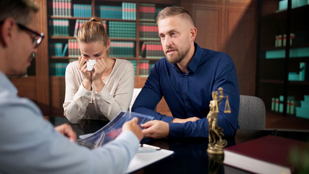 attorney-meeting-with-two-clients-across-a-desk