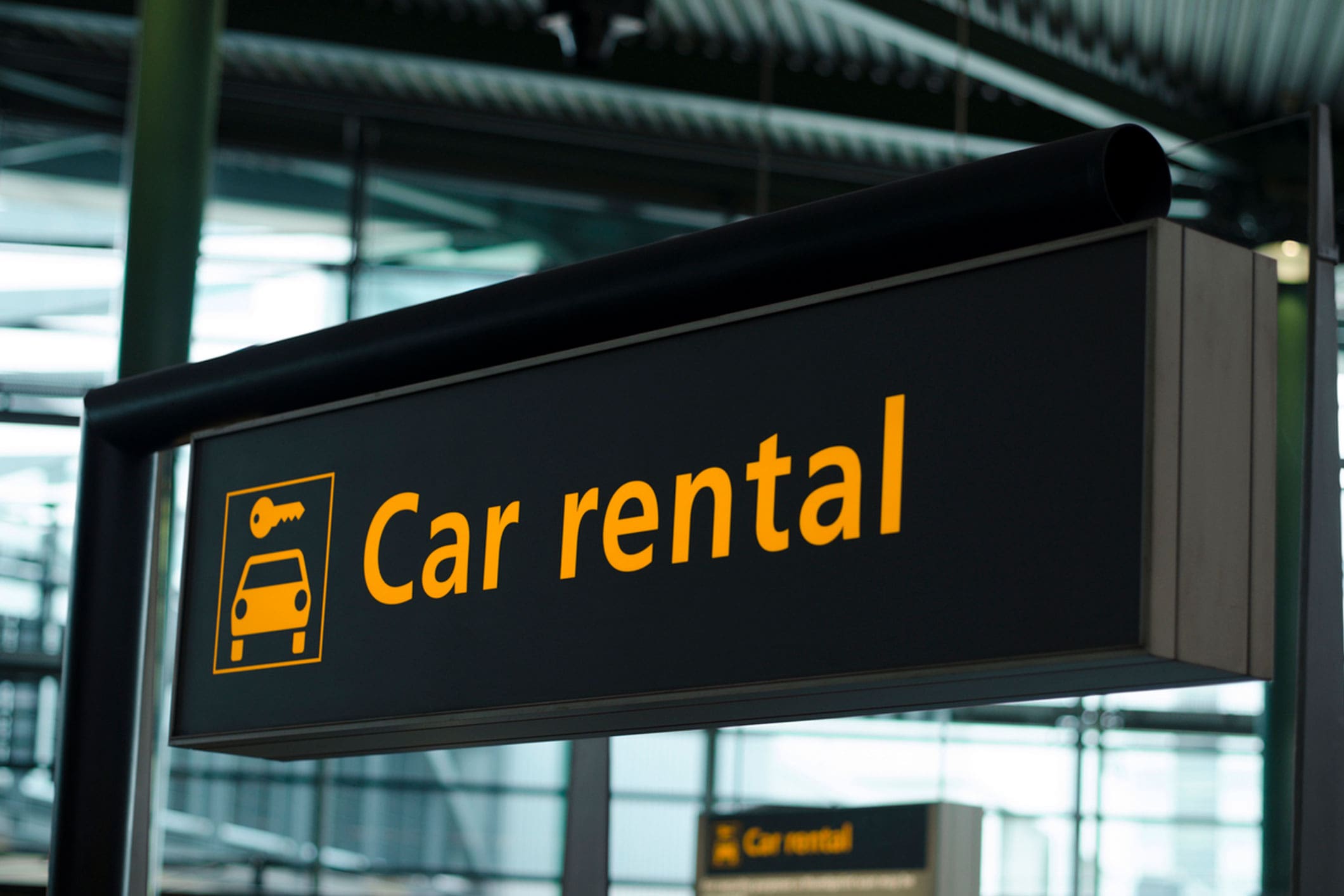 car-rental-sign-hanging-in-an-airport-terminal
