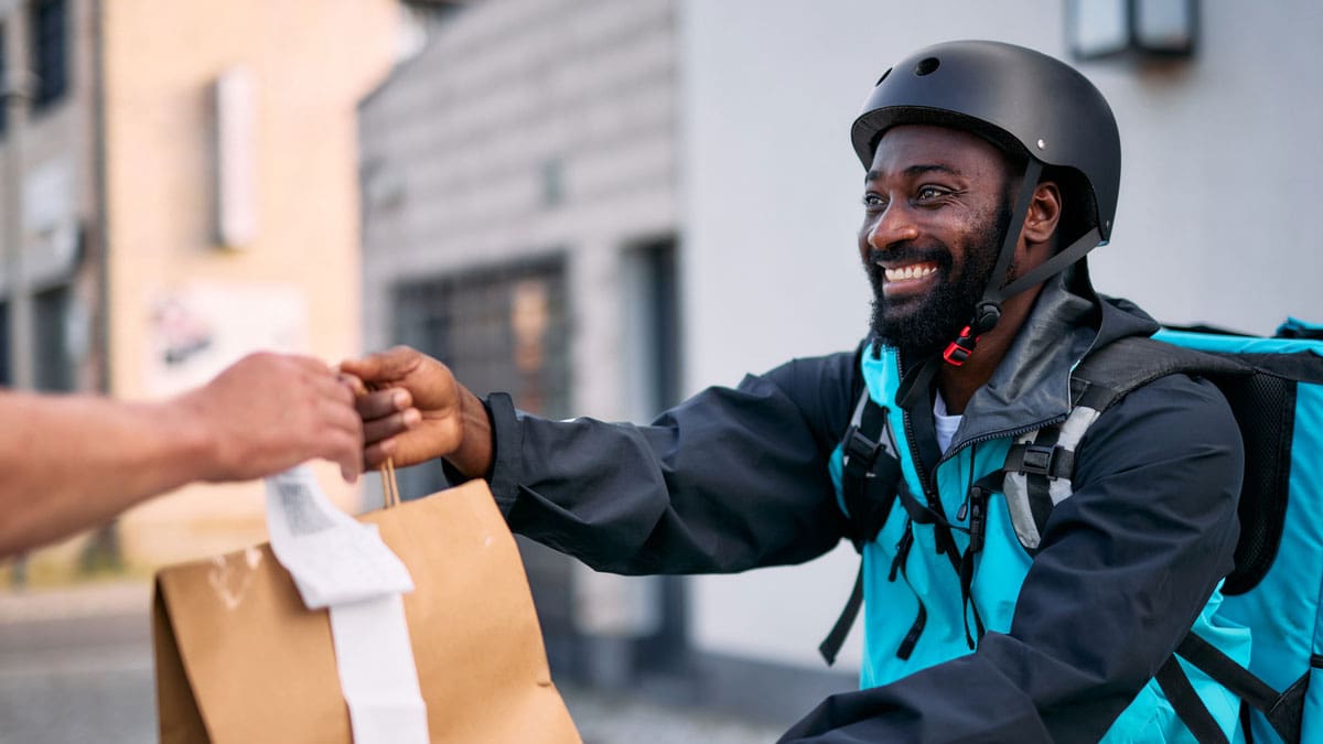 delivery-courier-handing-a-bag-to-a-customer