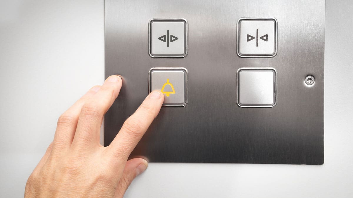hand-pressing-an-elevator-call-button