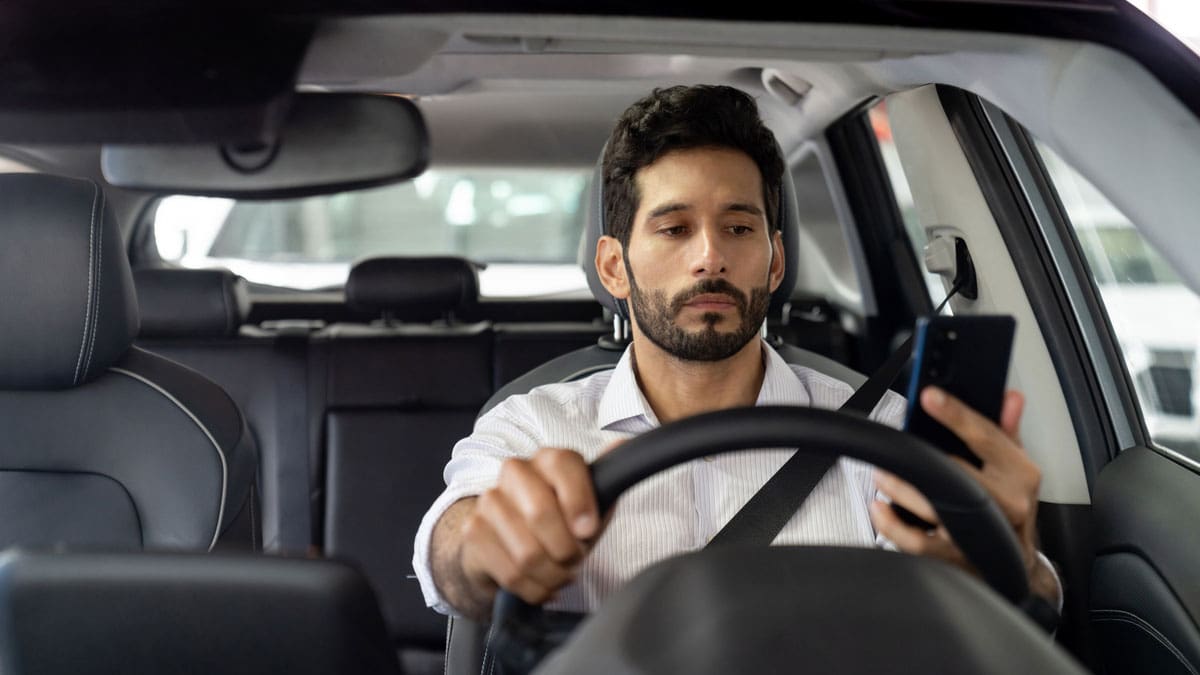 man-driving-with-both-hands-on-the-steering-wheel
