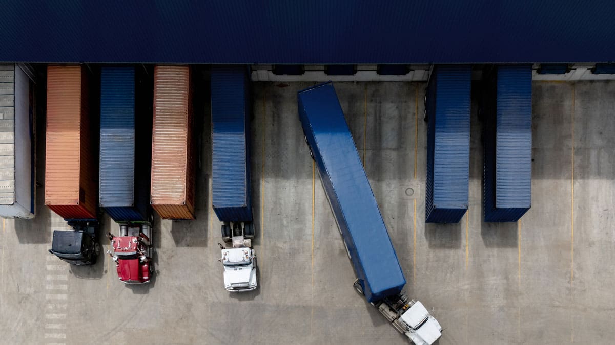 overhead-view-of-semi-trucks-parked-in-a-lot