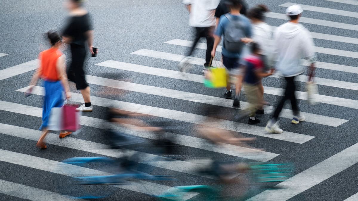 pedestrians-crossing-a-busy-street-in-a-crosswalk