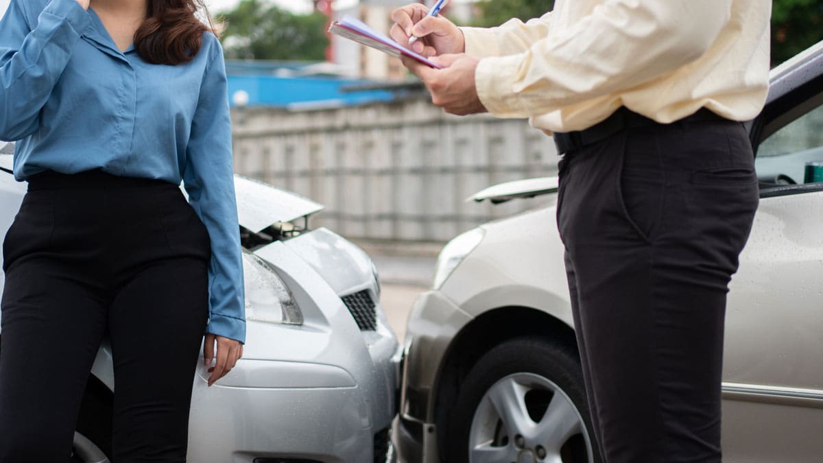 two-people-exchanging-information-beside-their-cars-after-a-collision