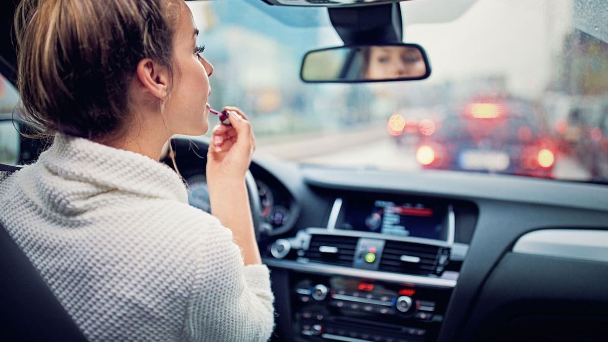 woman-on-her-phone-behind-the-wheel-in-heavy-traffic