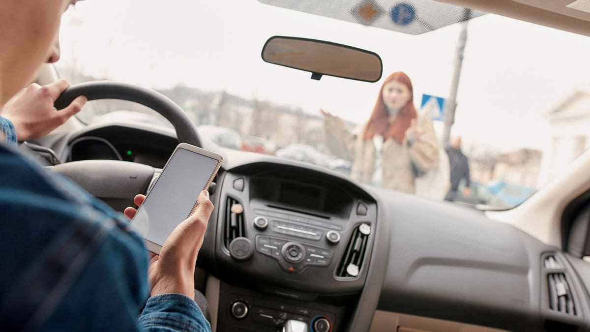 woman-using-her-phone-in-the-drivers-seat-after-a-collision